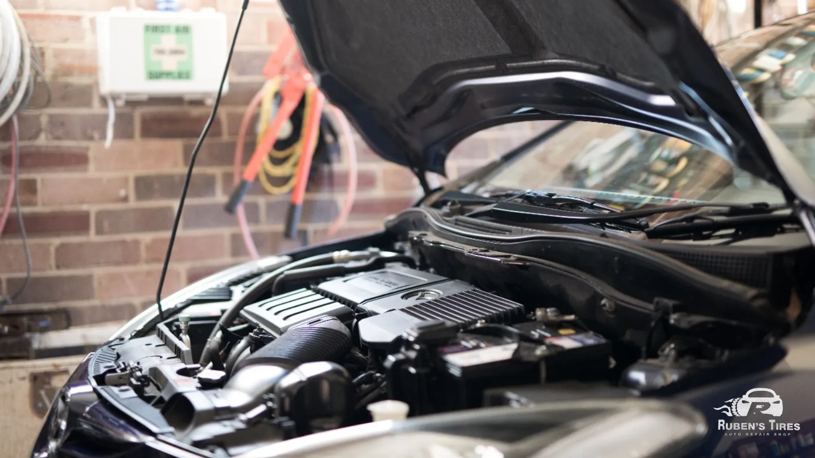 A car with its hood open ready for engine inspection and repair in South Semoran at Ruben's Tires.