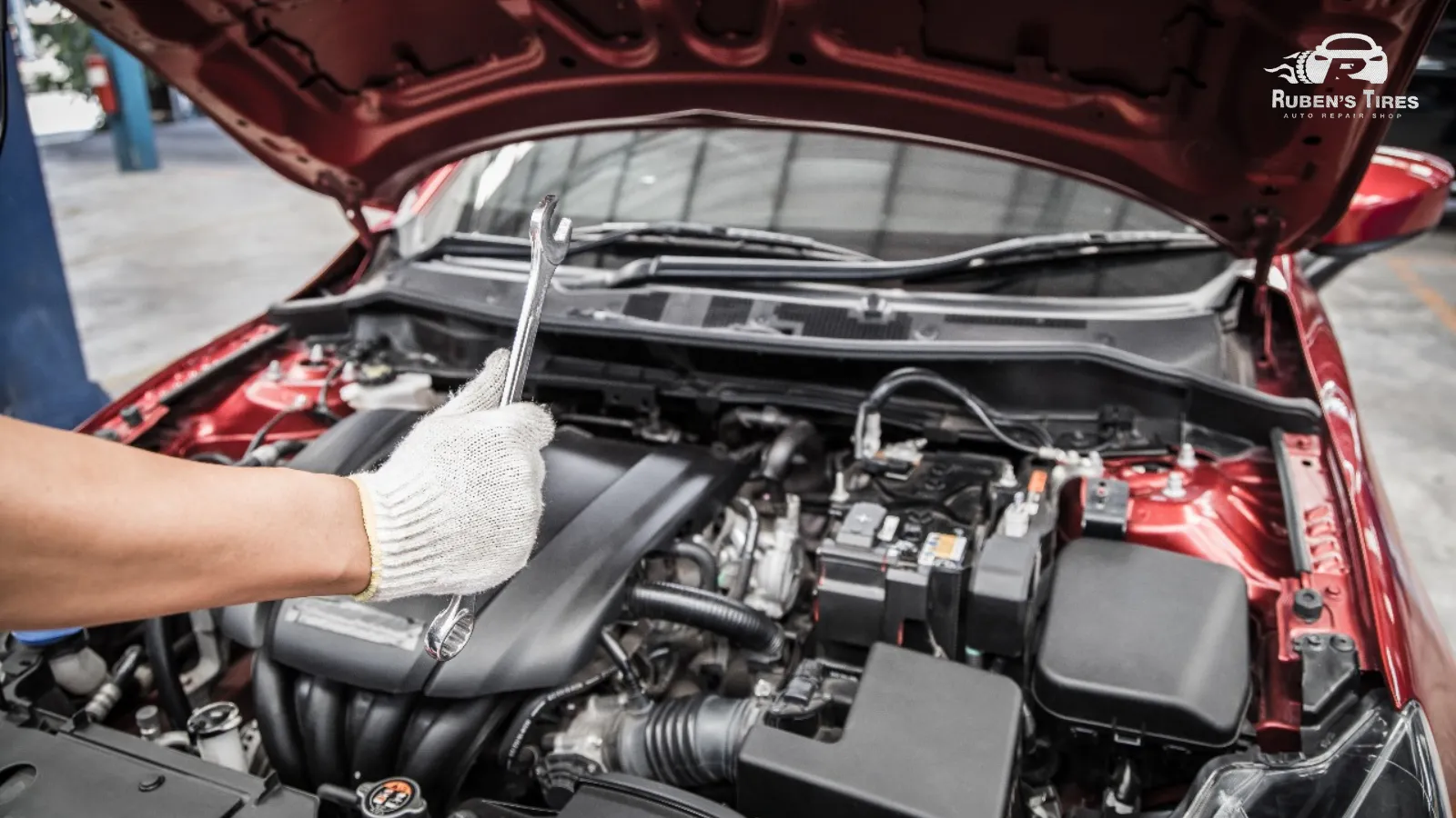 A mechanic holding a wrench during engine repair services at Ruben's Tires in South Semoran.