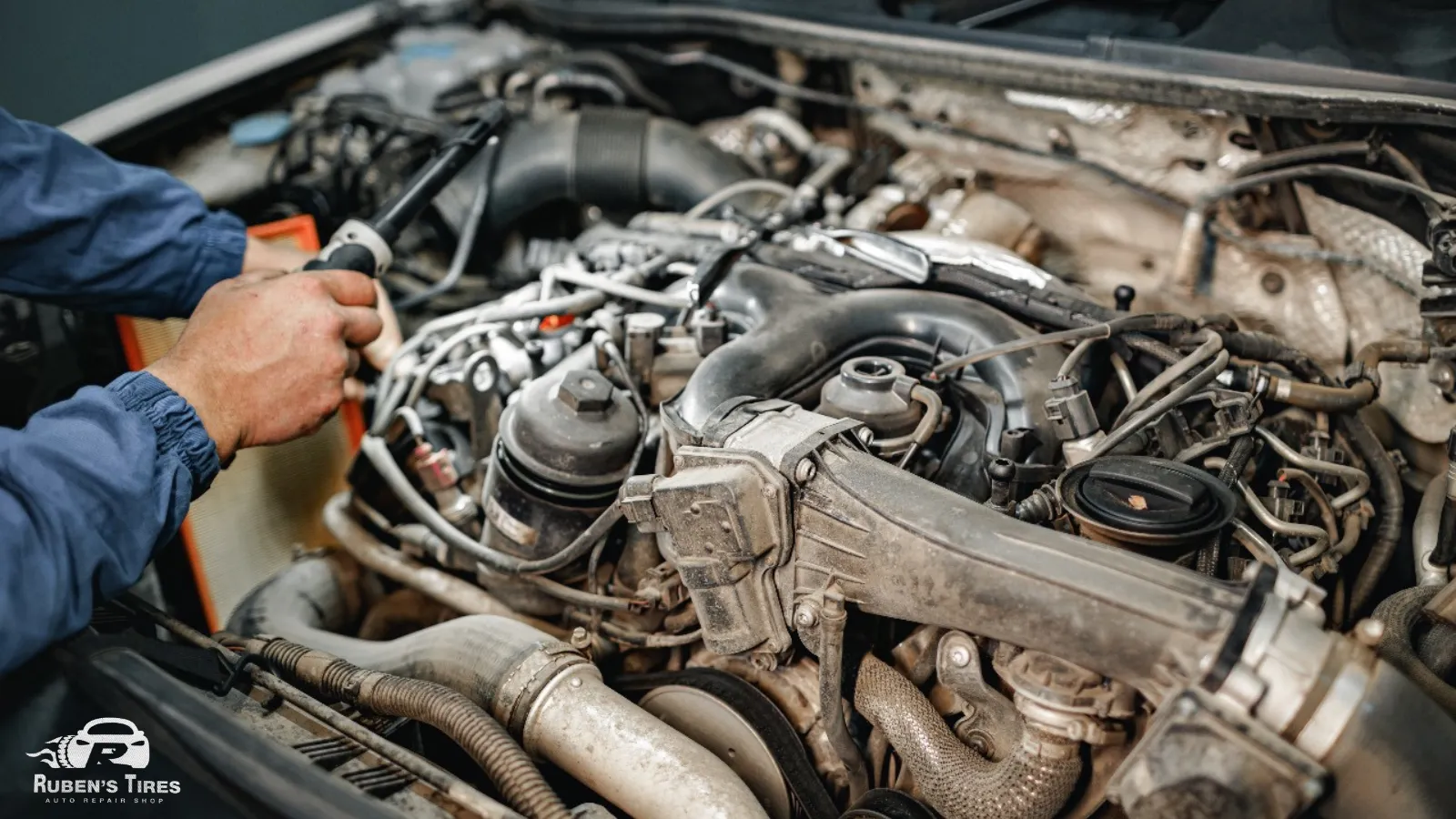 A mechanic working on an advanced car engine system at Ruben's Tires in South Semoran.