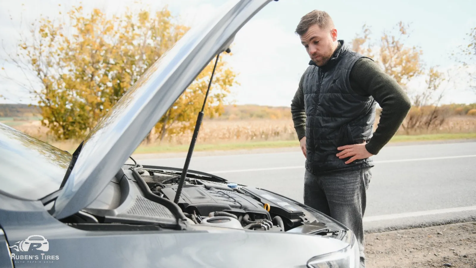 A man inspecting a car engine on the roadside near South Semoran, showcasing Ruben's Tires' reliability for engine repair.